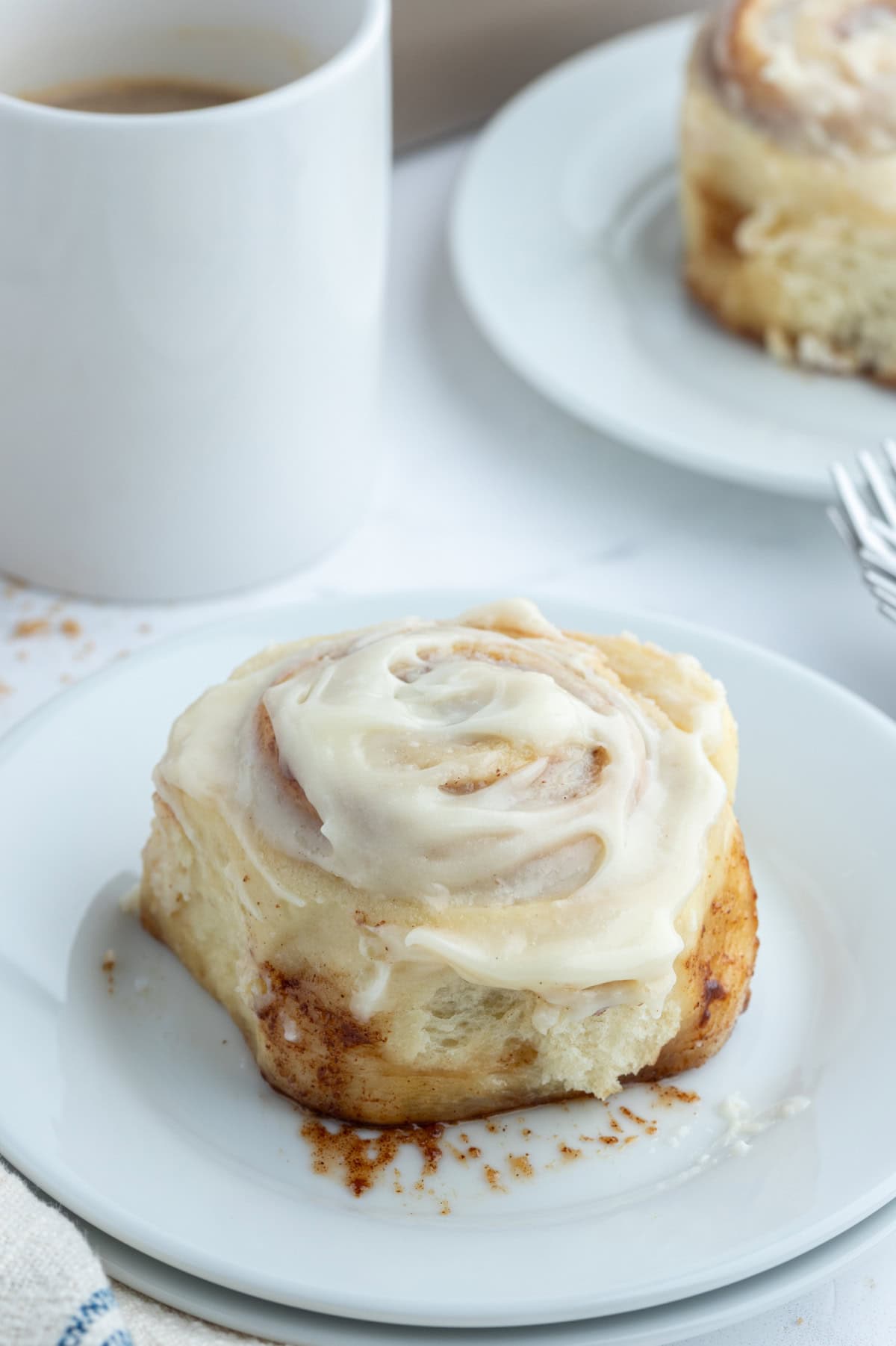 cinnamon roll on plate with icing