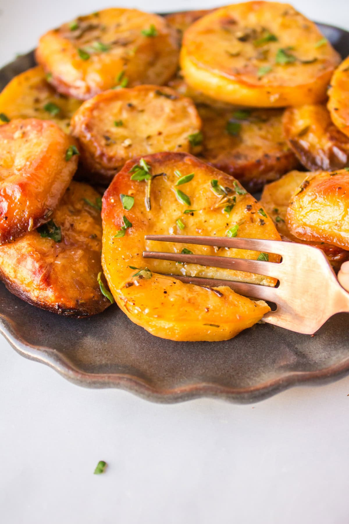 fork cutting into melting potatoes