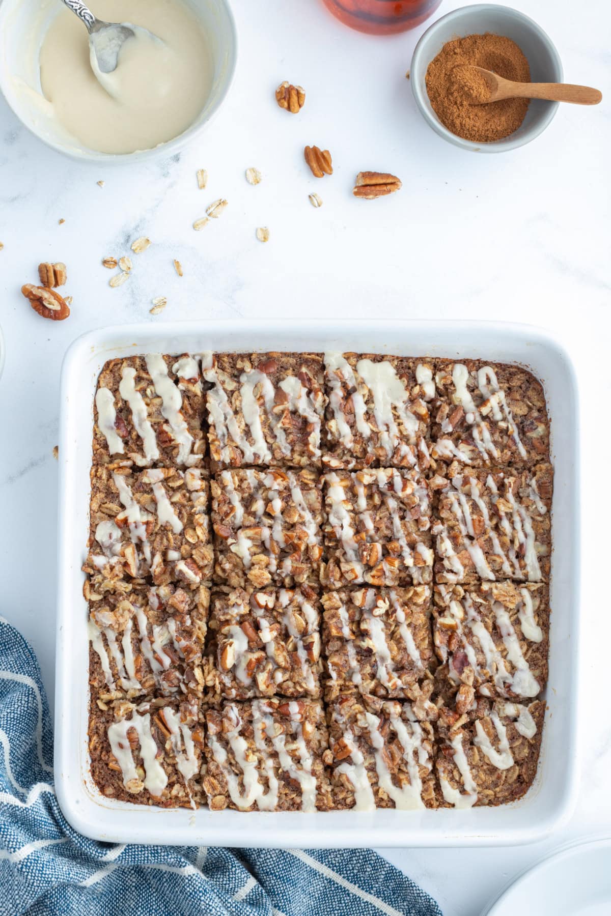 cinnamon roll baked oatmeal in a baking dish cut into squares