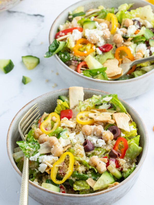 greek quinoa chopped salad in two bowls