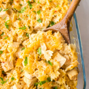 wooden spoon in pan of creamy lemon chicken pasta