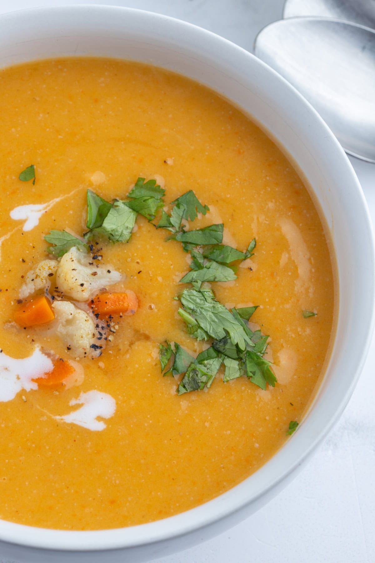 close up of bowl of instant pot cauliflower and sweet potato soup