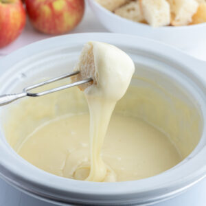 dunking bread into swiss cheese fondue