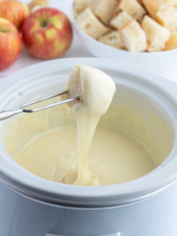 dunking bread into swiss cheese fondue