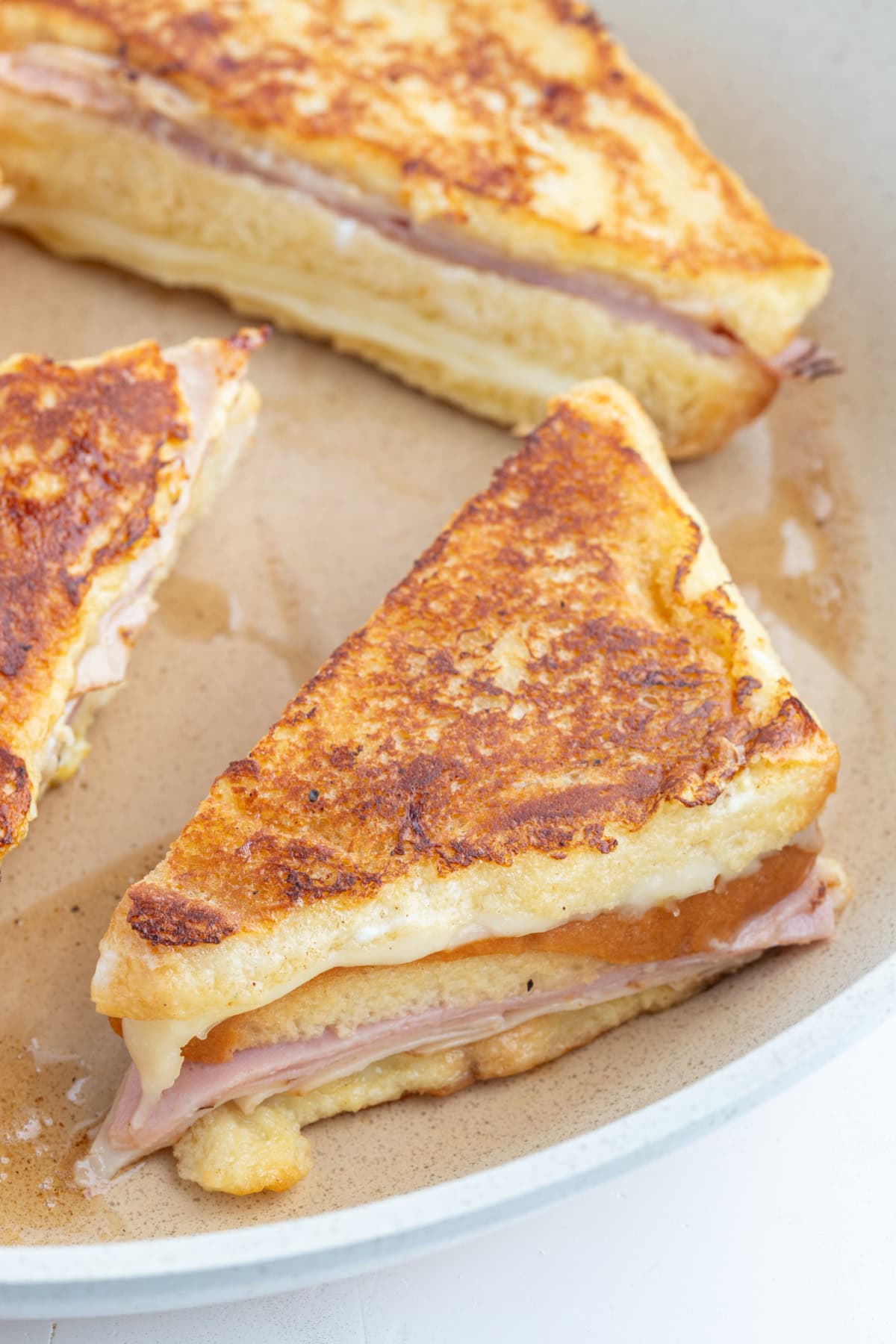 monte cristo sandwich halves on board after frying