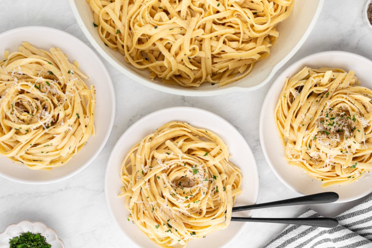 authentic alfredo sauce on fettuccine on serving plates