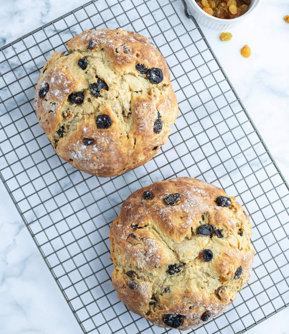 two loaves of sweet irish soda bread on rack