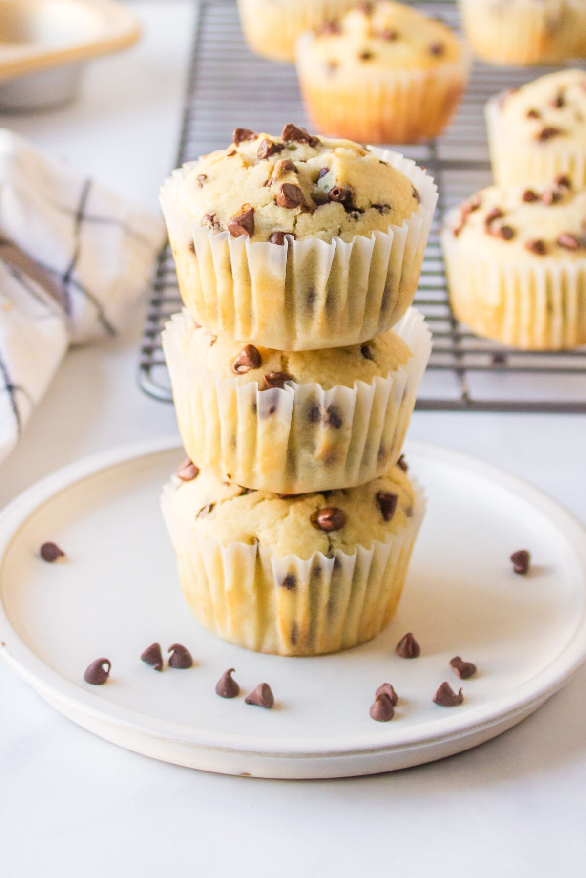 three stacked chocolate chip muffins