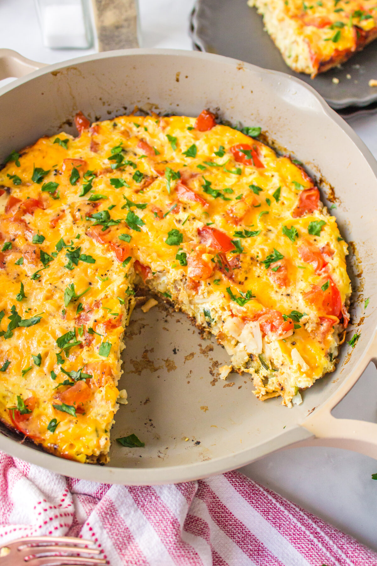 hash brown frittata in pan with slice taken out