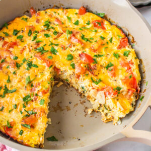 hash brown frittata in pan with slice taken out