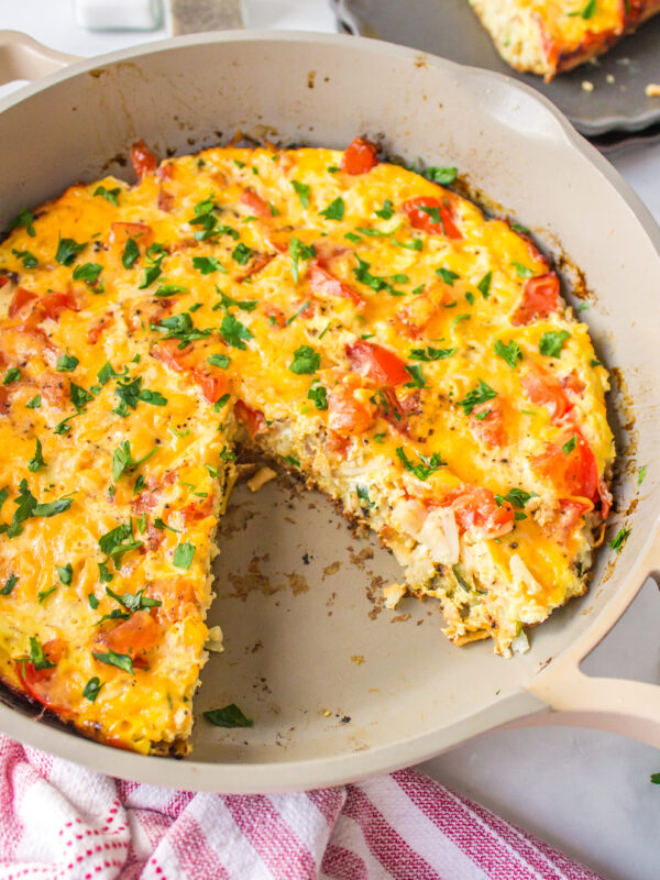 hash brown frittata in pan with slice taken out