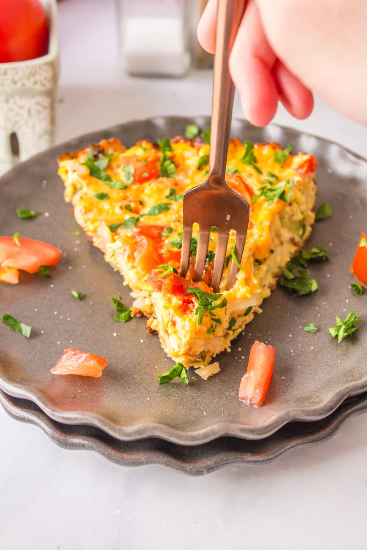 slice of hash brown frittata on plate with fork