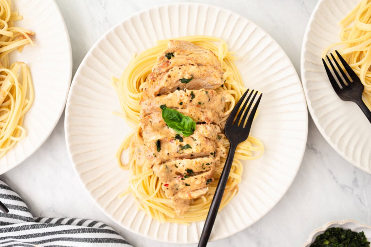 marry me chicken plated with pasta and fork